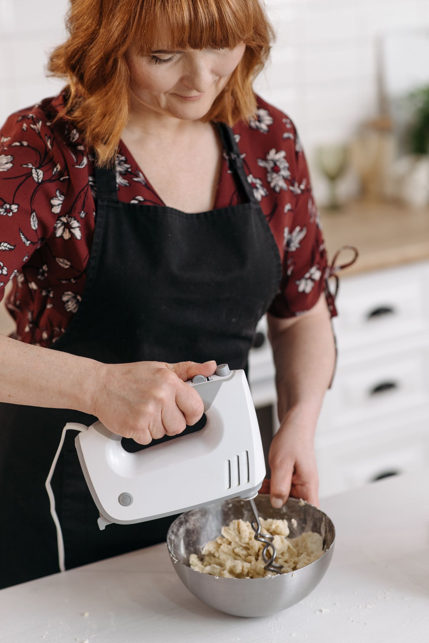Hand mixer used over mixing bowl