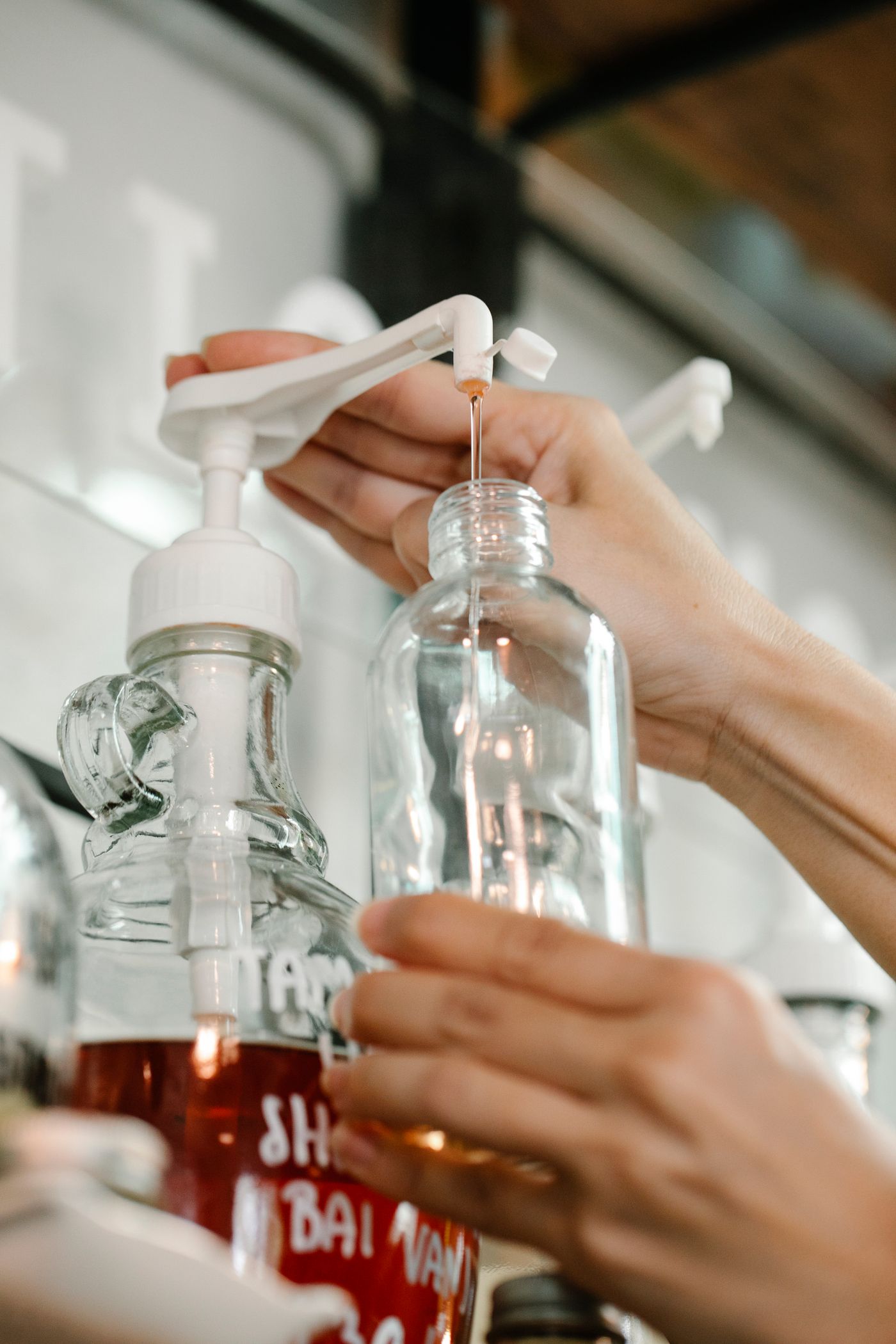 Refilling a reusable soap bottle