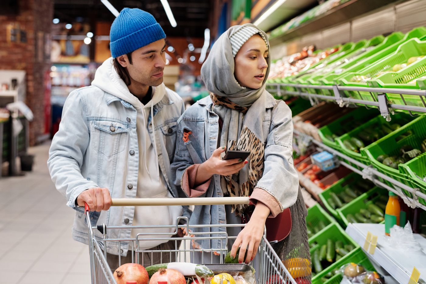 Two people discussing groceries while shopping