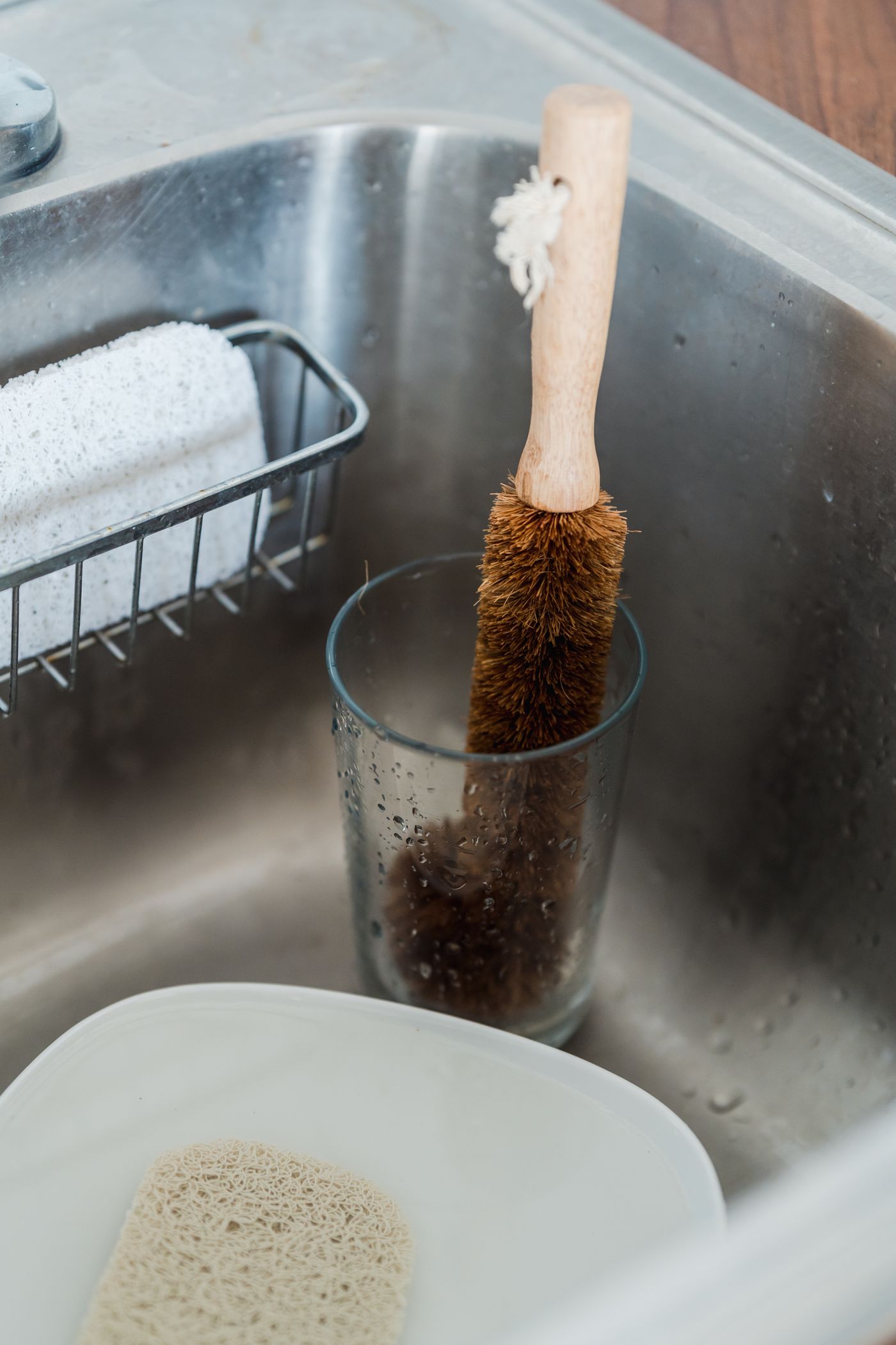 Dishwashing brush in a glass at the sink