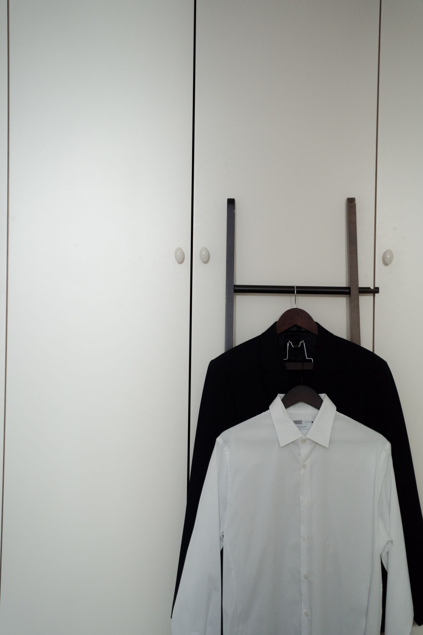 Black and white shirts in a wardrobe