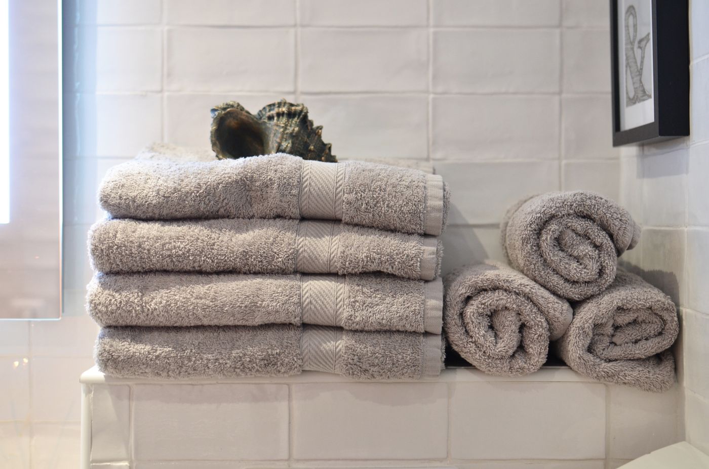 Folded towels on bathroom shelf